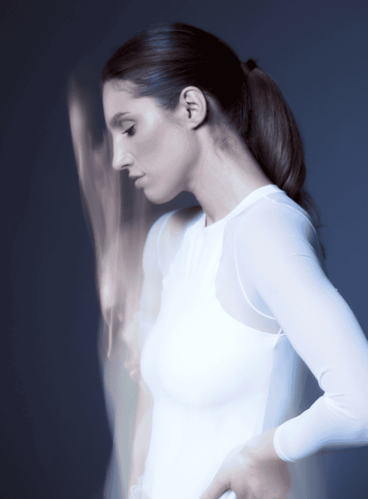 Woman in white athletic outfit, demonstrating concentration and serenity, with a dynamic motion blur.